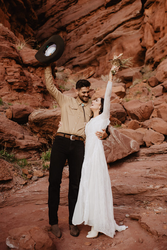 Utah elopement photographer captures couple celebrating recent marriage in Moab