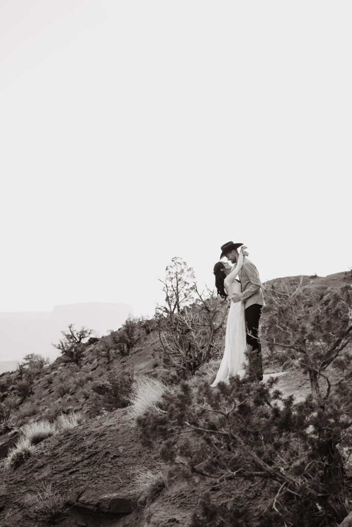 Utah elopement photographer captures black and white image of couple kissing