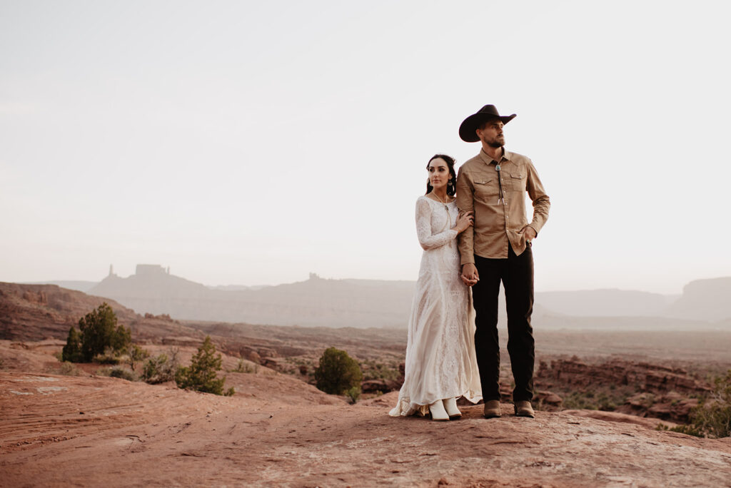 Utah elopement photographer captures groom wearing cowboy hat in Moab