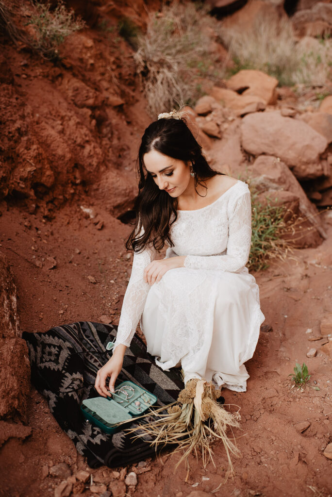 Utah elopement photographer captures bride looking at vow book before Moab elopement ceremony