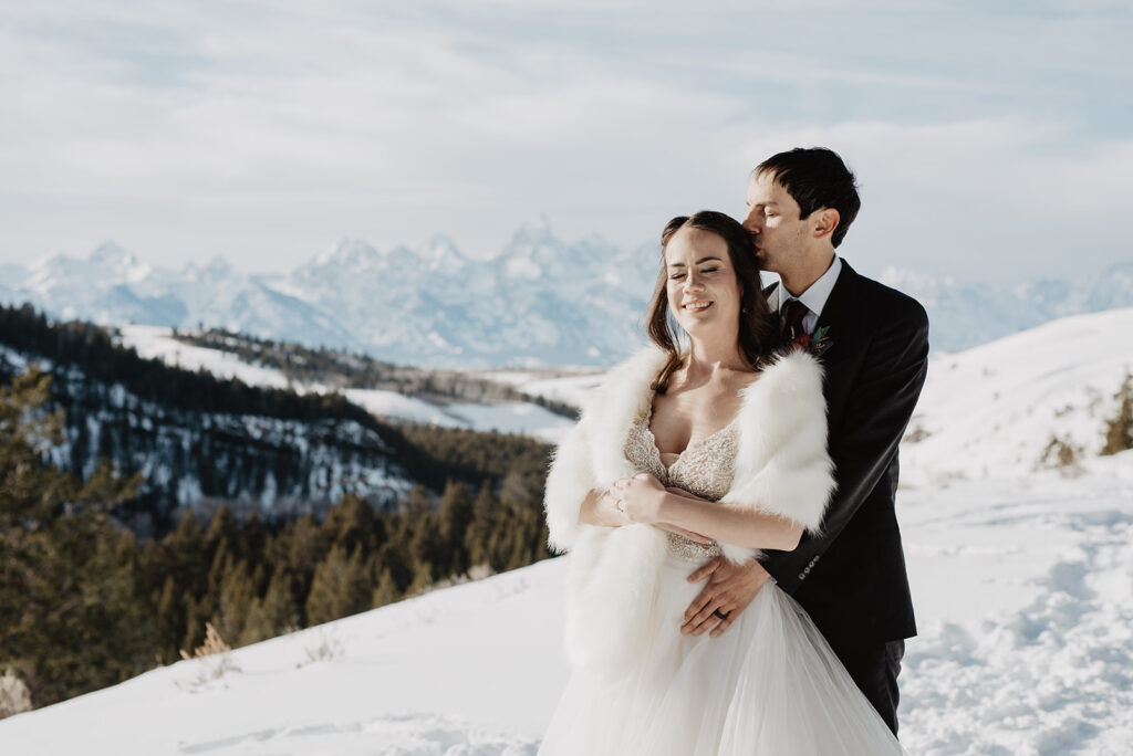 Grand Teton photographer captures bride and groom hugging in winter wedding