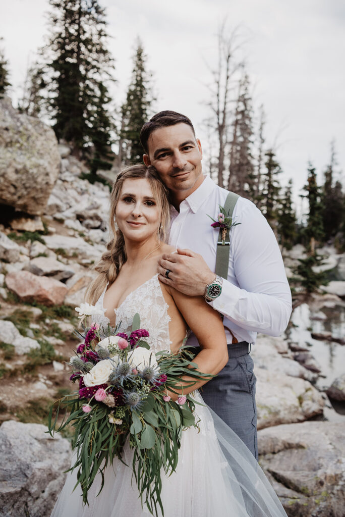 Jackson Hole photographer captures couple in wedding attire holding bouquet