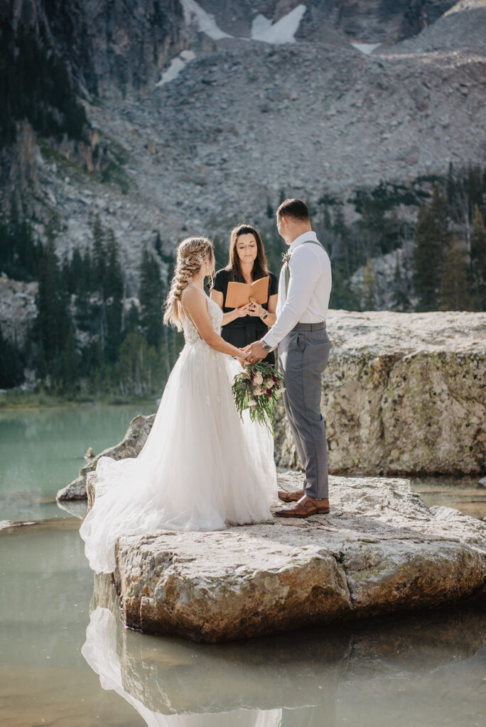 Jackson Hole photographer captures couple holding hands during elopement ceremony