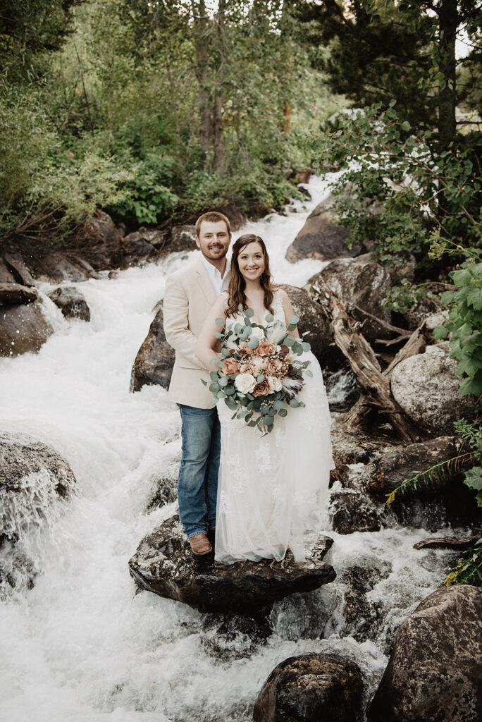 Jackson Hole wedding photographer captures bride and groom hugging during outdoor bridal portraits
