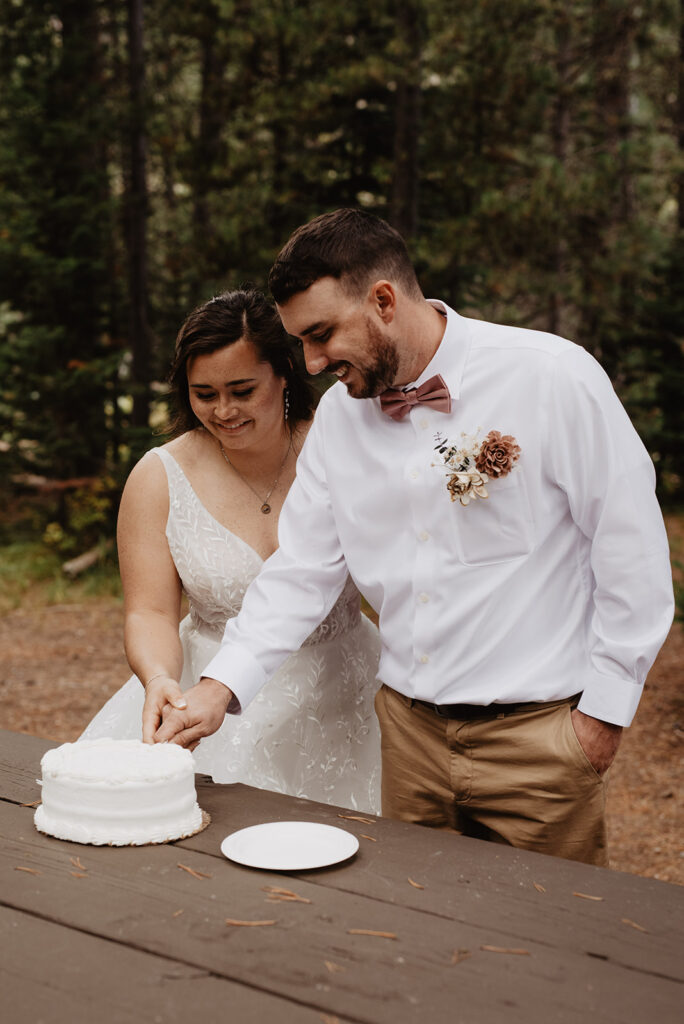 Photographers Jackson Hole capture couple cutting cake 