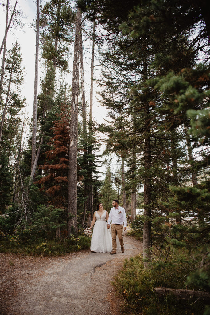 Photographers Jackson Hole capture couple walking through forest together