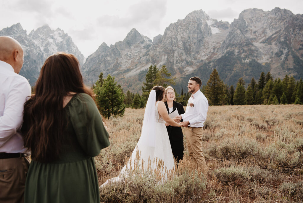 Photographers Jackson Hole capture couple holding hands during elopement ceremony in Jackson Hole