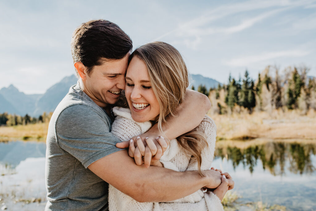 Jackson Hole Photographer captures man hugging woman from behind during engagement photos