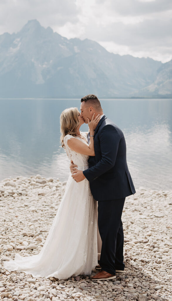 Photographers Jackson Hole capture couple kissing as newly married husband and wife