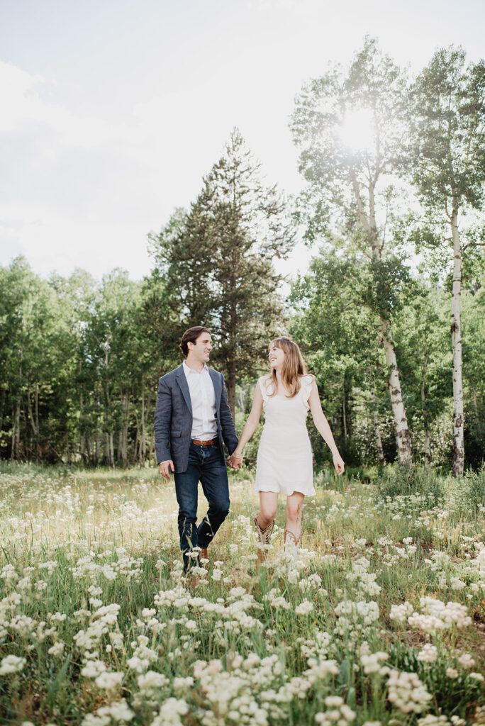 Jackson Hole Photographer captures couple walking through meadow 