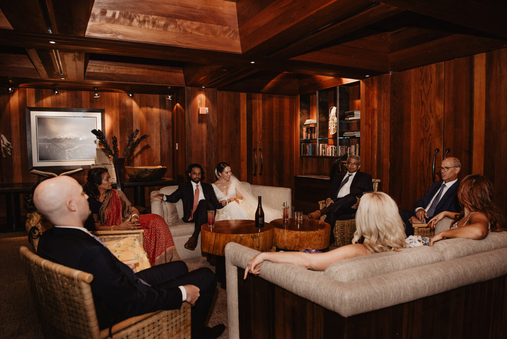 Jackson Hole Wedding Photographer captures groom sitting with groomsmen before Amangani wedding