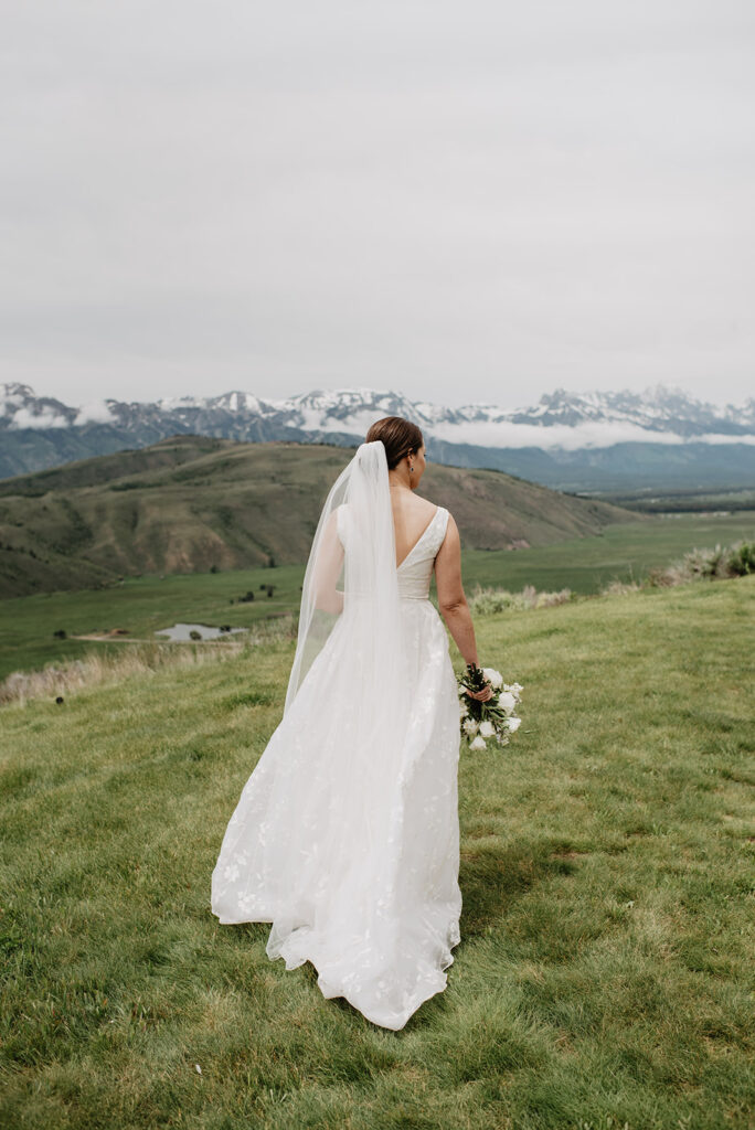 Jackson Hole Wedding Photographer captures bride walking in wedding gown 