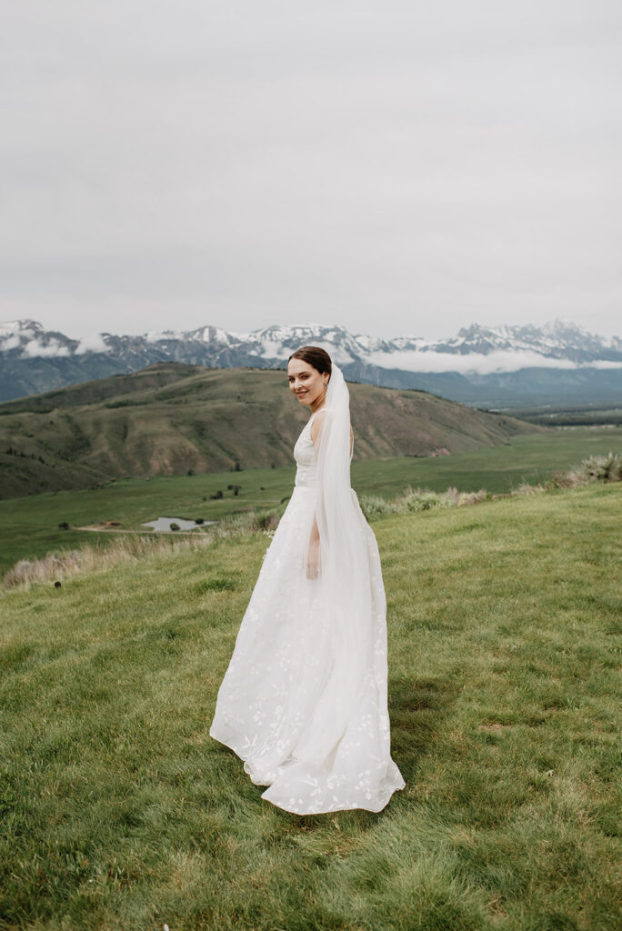 Jackson Hole wedding photographer captures bride walking in field