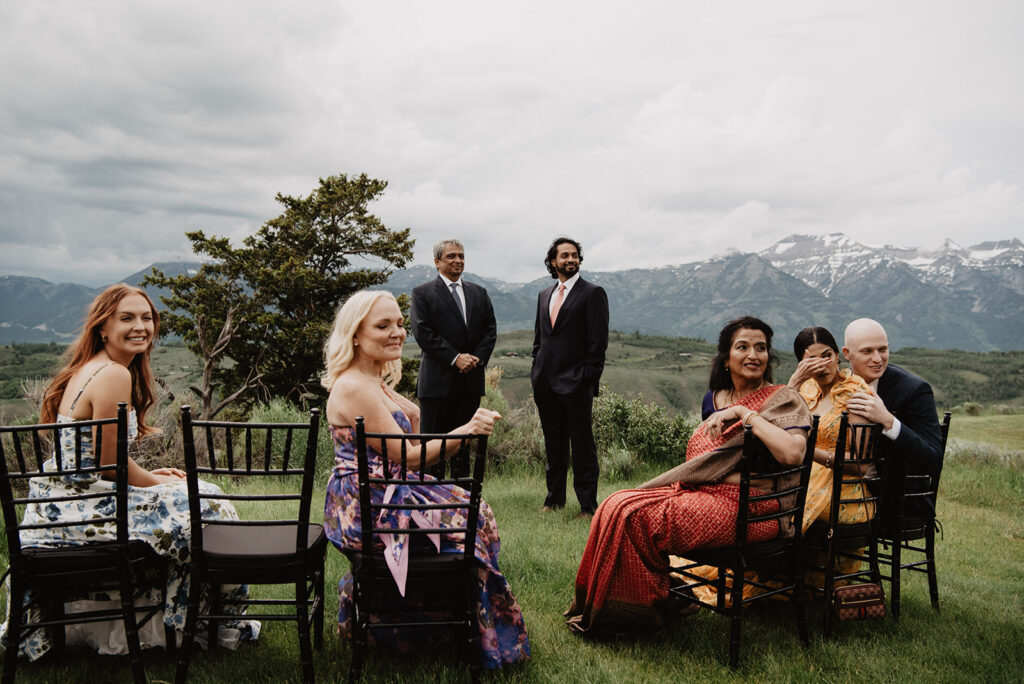 Jackson Hole wedding photographer captures groom standing at ceremony waiting for bride to walk down aisle