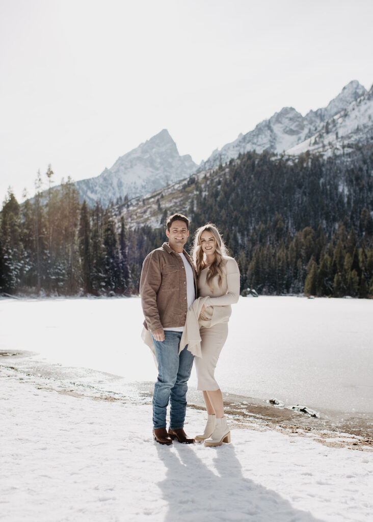 Jackson Hole wedding photographer captures couple smiling together after surprise proposal