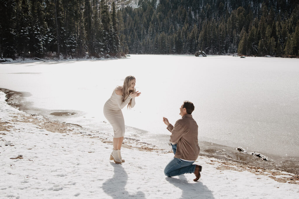 Jackson Hole wedding photographer captures man proposing to woman during surprise proposal