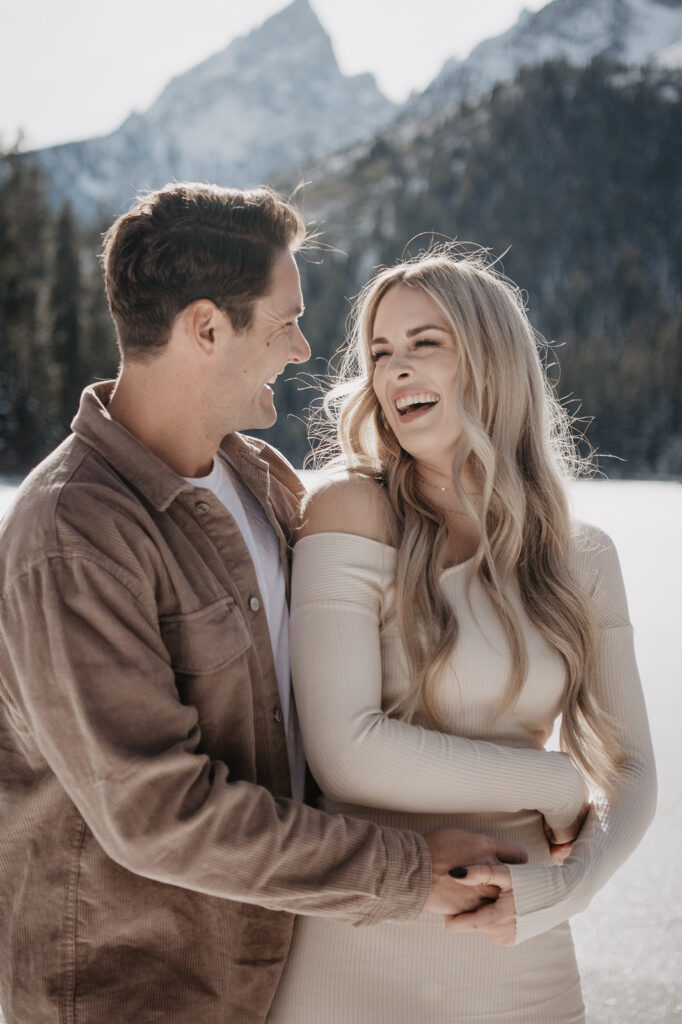 Jackson Hole wedding photographer captures woman laughing while man hugs her