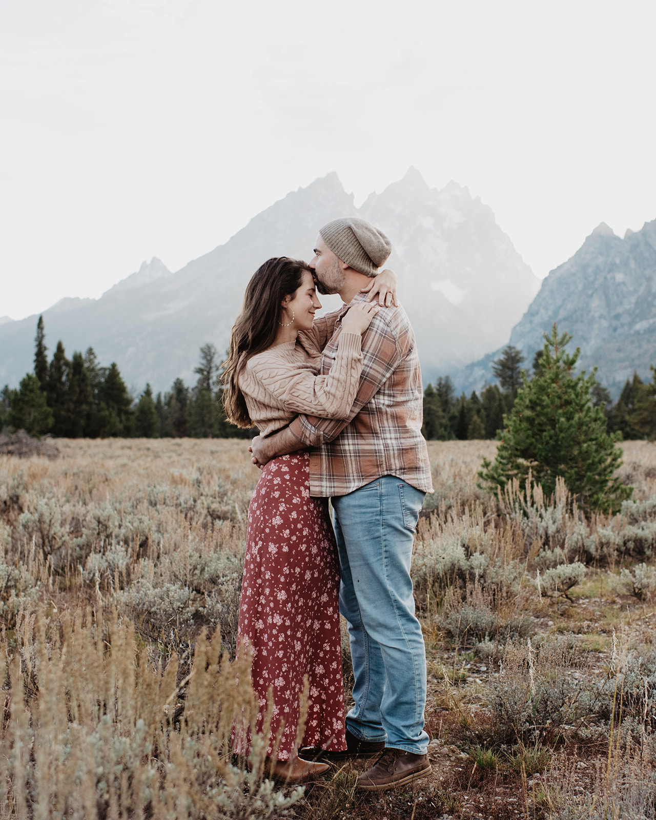 Jackson Hole Photographer captures man kissing woman's forehead during engagements
