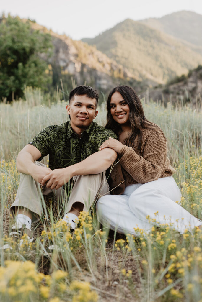 Utah elopement photographer captures couple sitting in grass 