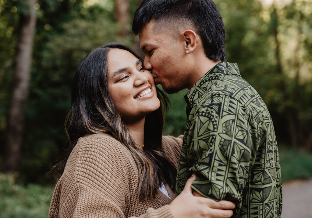 Utah elopement photographer captures man kissing woman's cheek during engagement photos