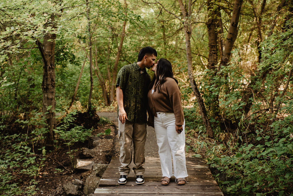 Utah elopement photographer captures couple standing on bridge together