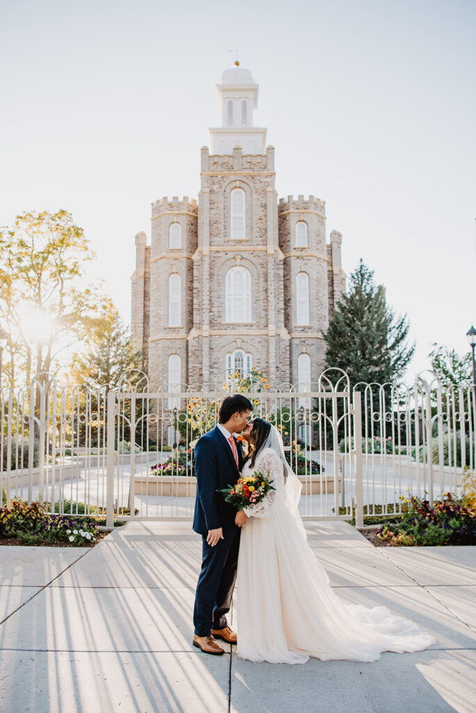 Utah Elopement Photographer captures bride and groom kissing in front of LDS Temple