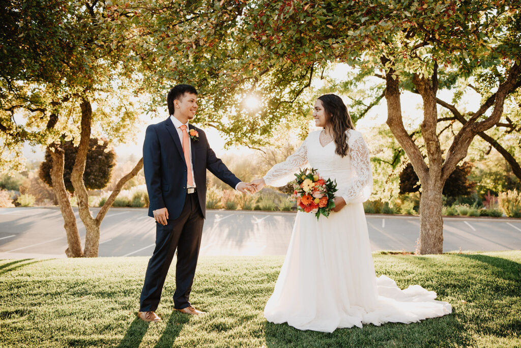 Utah elopement photographer captures bride and groom holding hands during outdoor bridal portraits at LDS Temple
