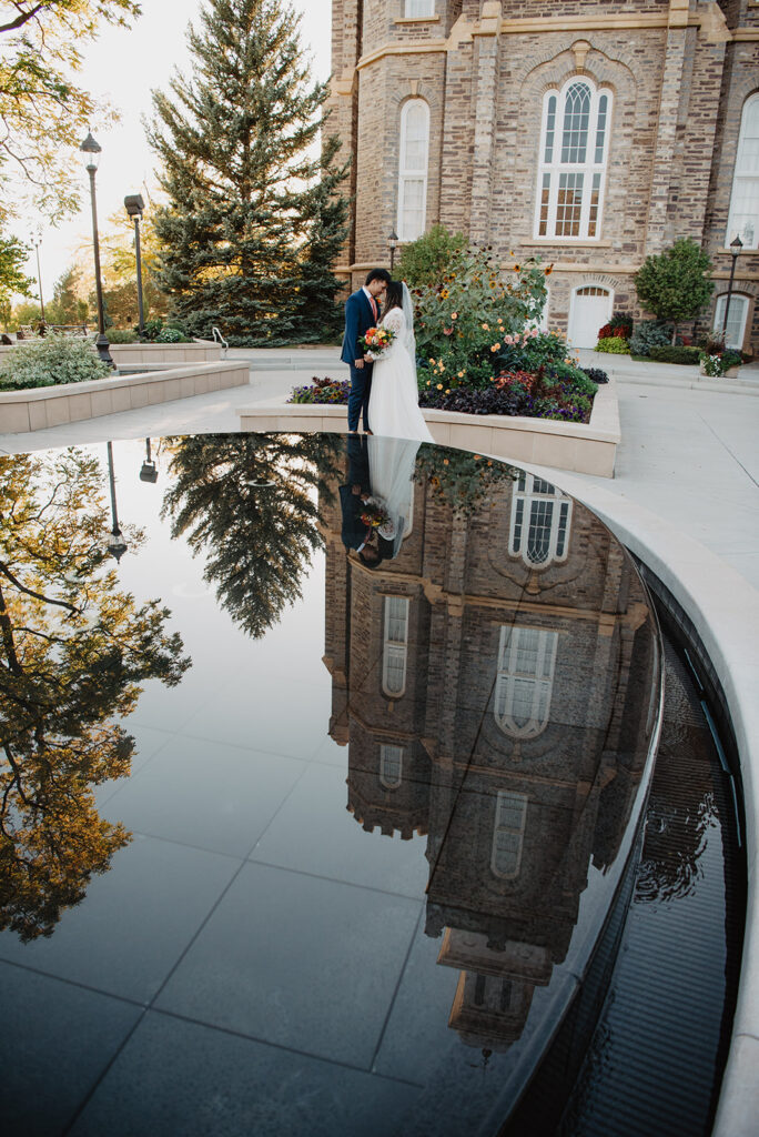 Utah elopement photographer captures bride and groom embracing in front of water