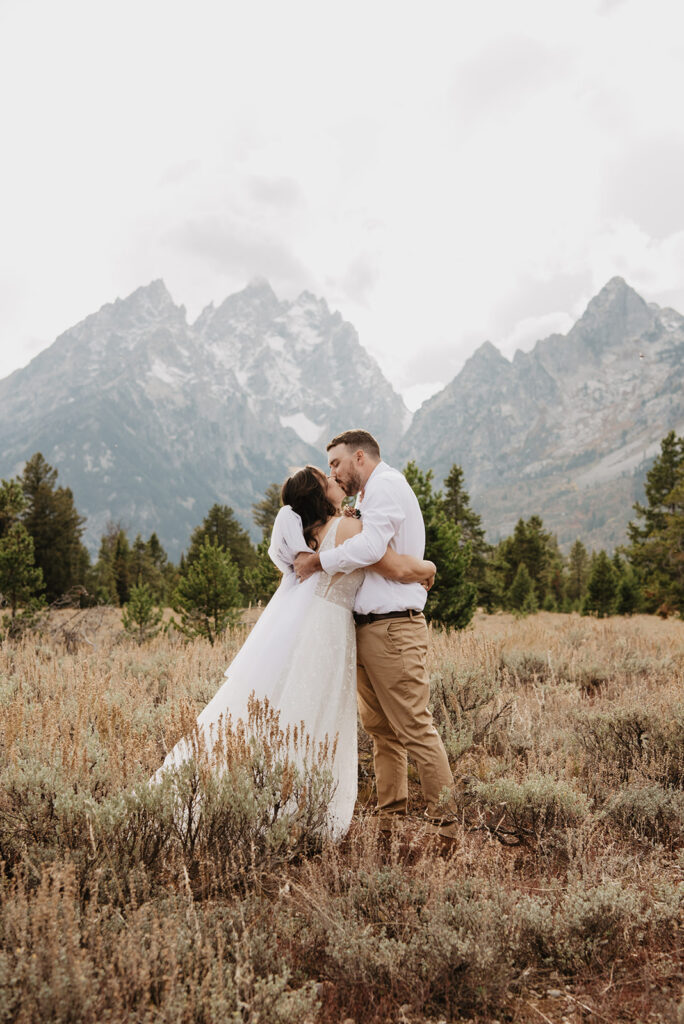 Jackson Wy photographer captures bride and groom hugging in Grand Teton National Park after elopement