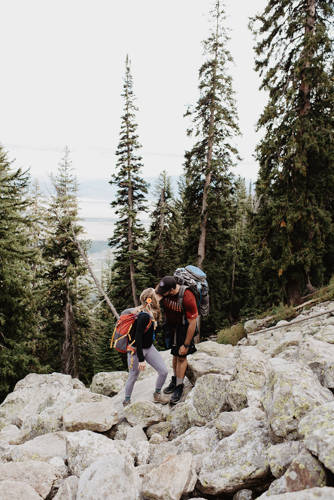 Jackson Wy photographer captures couple hiking through park with hiking backpacks