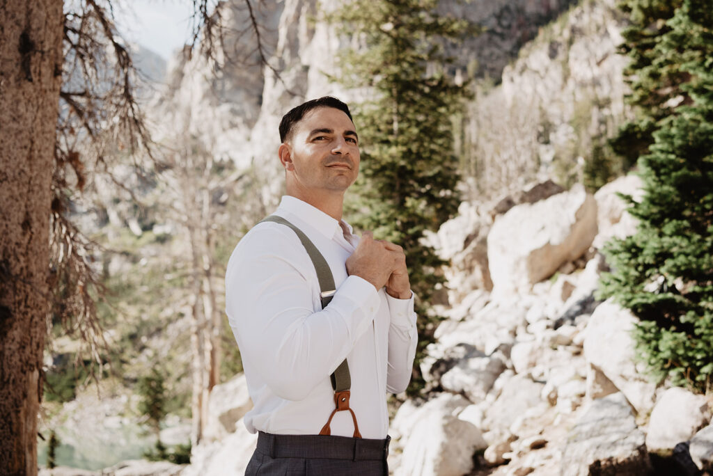 Jackson Wy photographer captures groom buttoning shirt for Grand Teton elopement