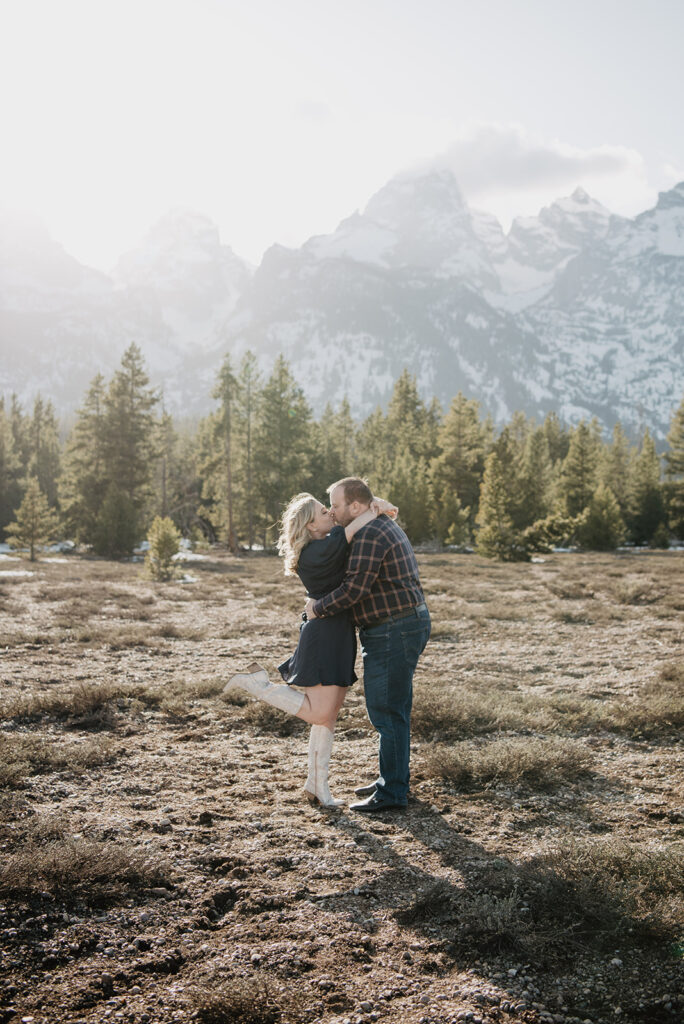 Jackson Wy photographer captures man and woman kissing while woman pops foot