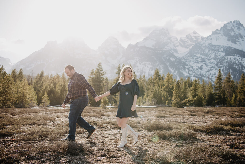 Jackson Wy photographer captures couple walking through park during Jackson hole honeymoon