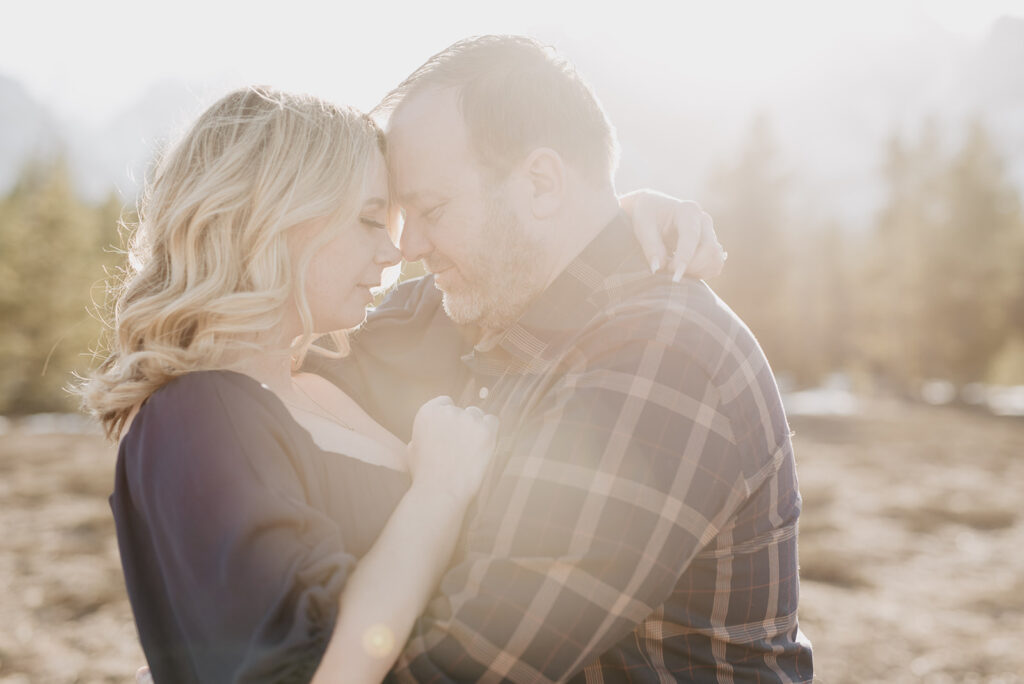 Jackson Wy photographer captures man and woman touching foreheads during golden hour honeymoon portraits