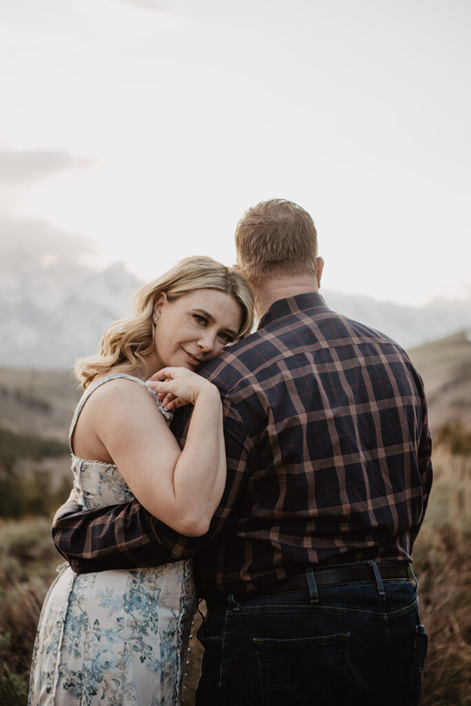 Jackson Wy photographer captures woman hugging man's arm and leaning on his shoulder 