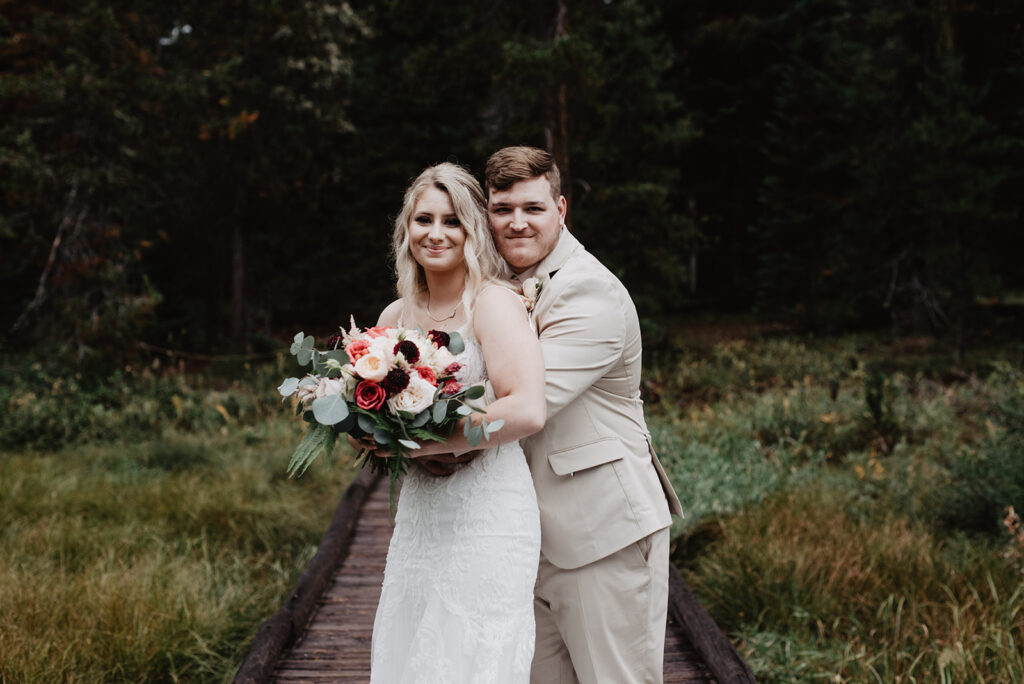 Jackson Hole Wedding Photographer captures groom hugging bride 