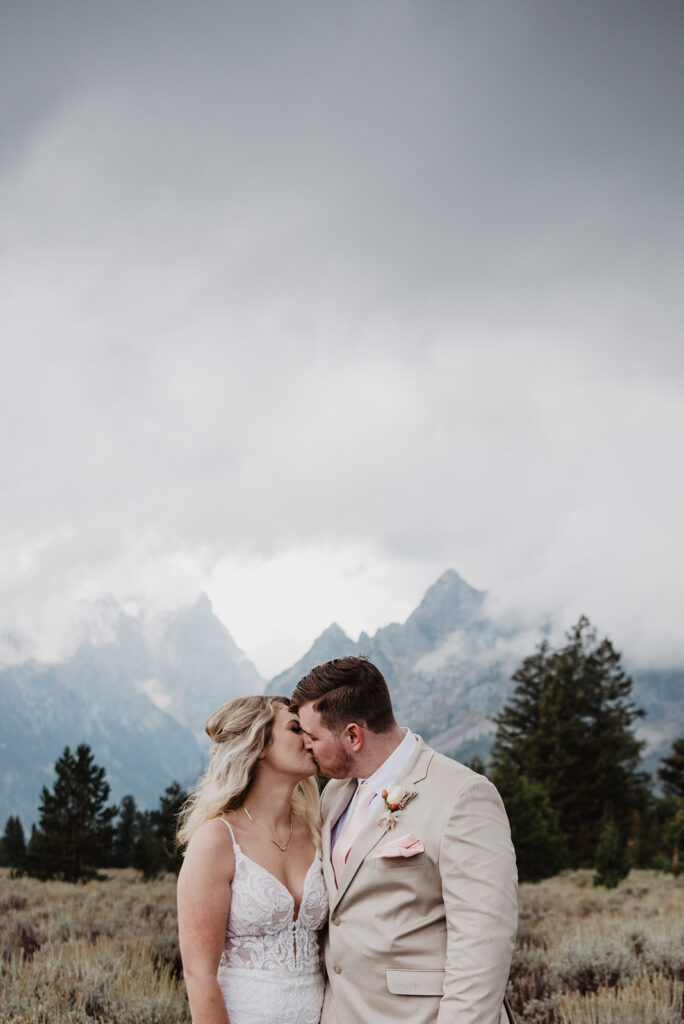 Jackson Hole Wedding Photographer captures couple kissing during bridal portraits