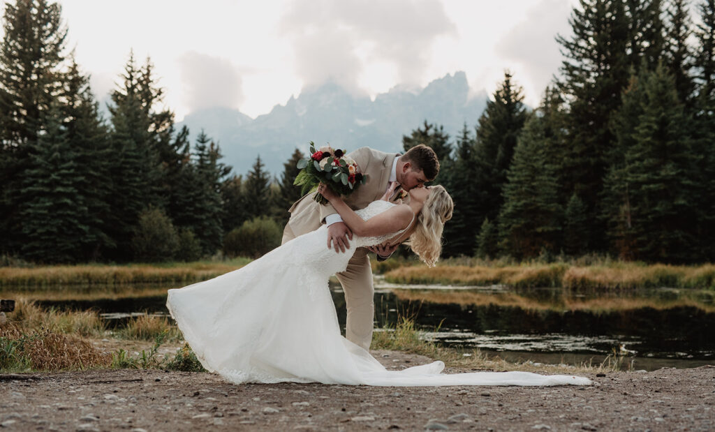 Jackson Hole Wedding Photographer captures bride and groom kissing in front of Tetons