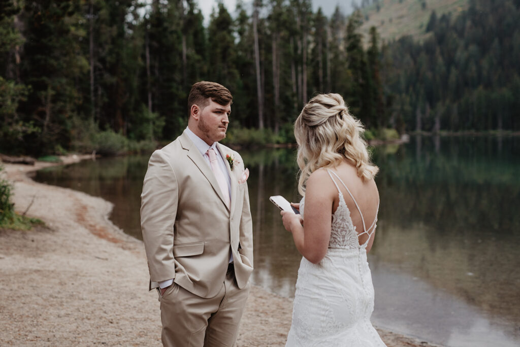 Jackson Hole Wedding Photographer captures private vow reading while bride reads vows
