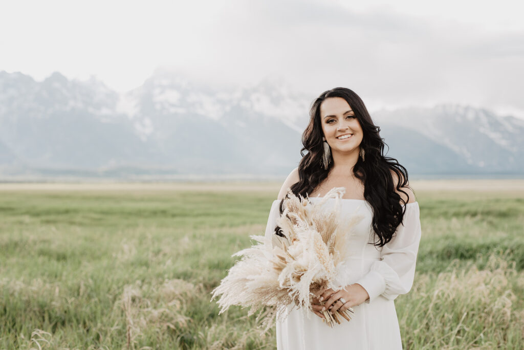 Wyoming Elopement Photographer captures bride holding boho bridal bouquet