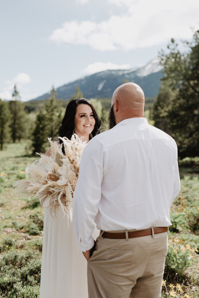 Wyoming Elopement Photographer captures bride and groom looking at one another during elopement ceremony