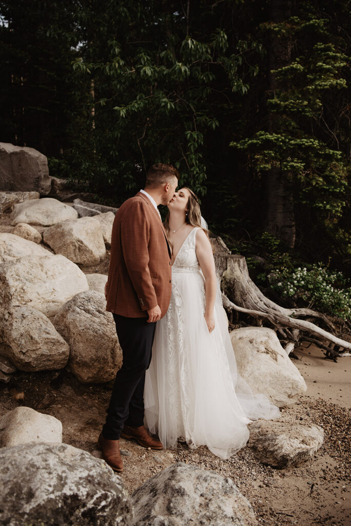 Grand Teton Wedding Photographer captures bride and groom kissing during adventure bridal portraits