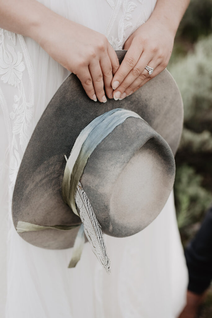 Grand Teton Wedding Photographer captures bride holding hat