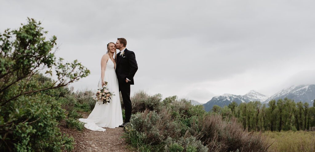 Jackson Hole Elopement Photographer captures bride and groom together at top of mountain