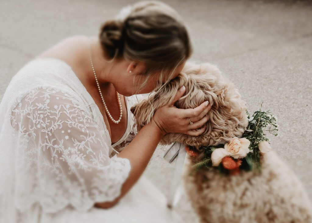 Jackson Hole Elopement Photographer captures bride kissing dog on wedding day