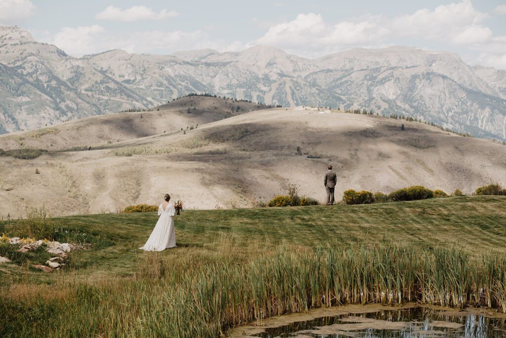 Jackson Hole Elopement Photographer captures bride walking towards groom during first look
