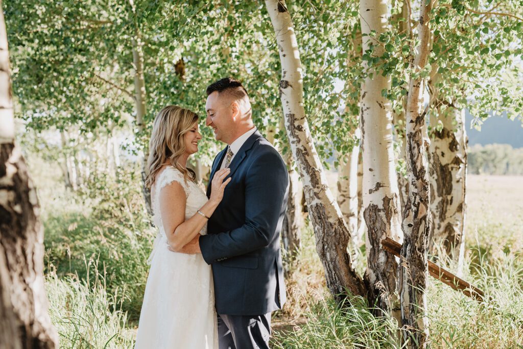 Jackson Hole Photographer captures bride and groom in forest during bridals