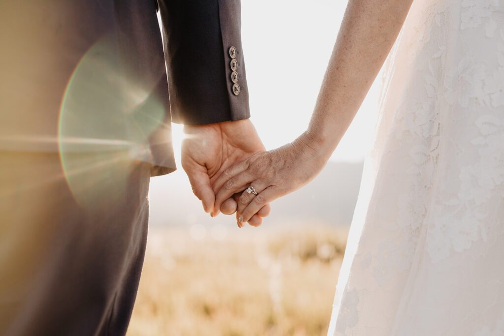 Jackson Hole Photographer captures bride and groom holding hands  