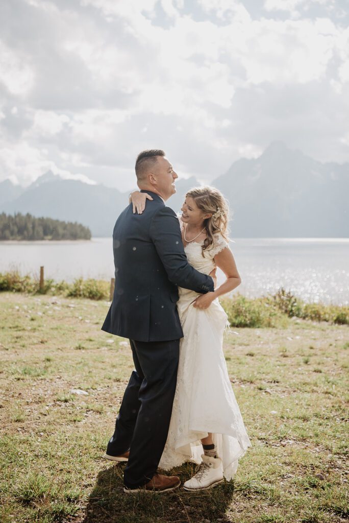 Jackson Hole Photographer captures groom holding bride during bridal portraits