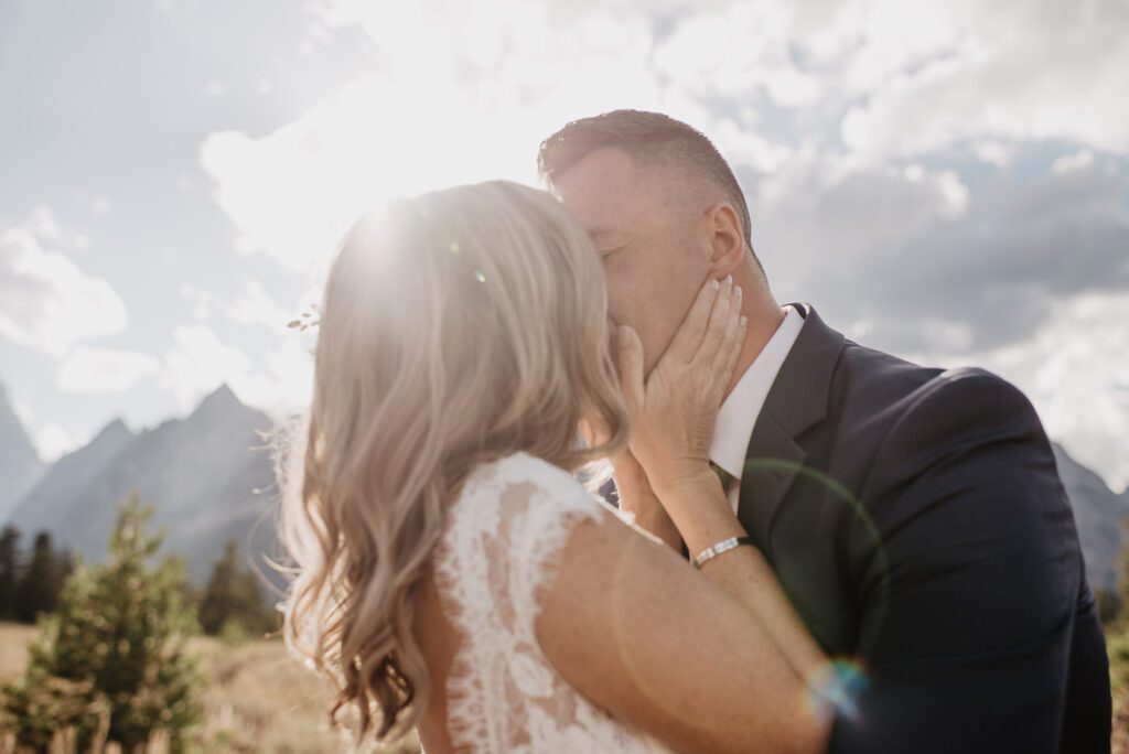 Jackson Hole Photographer captures bride grabbing groom's face to kiss him